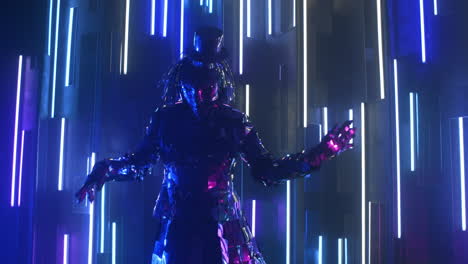 Steel-female-in-a-sparkling-reflective-suit.-Neon-light-Blue-violet-light.-Show-dancer.